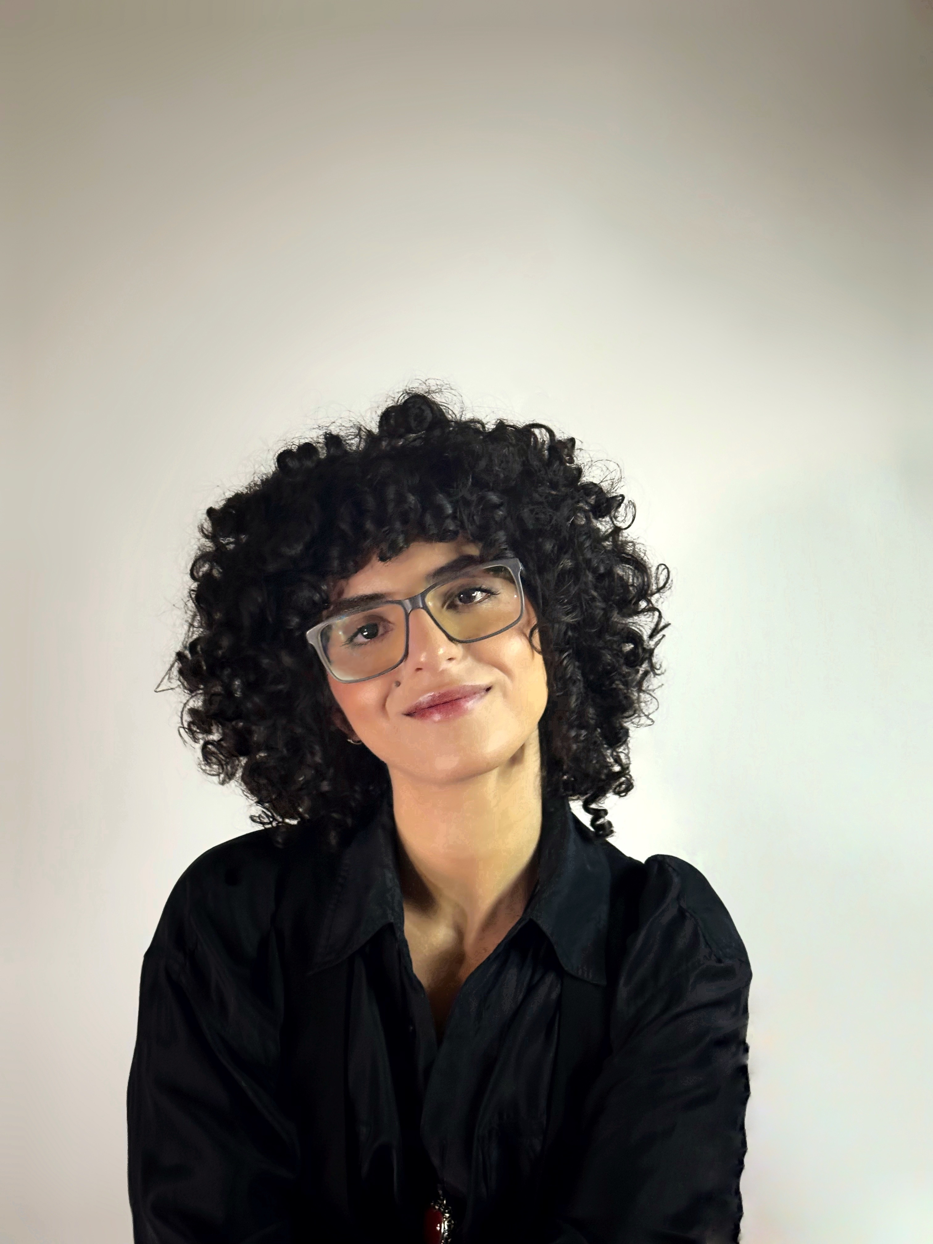 Ichrak with a warm, welcoming smile.